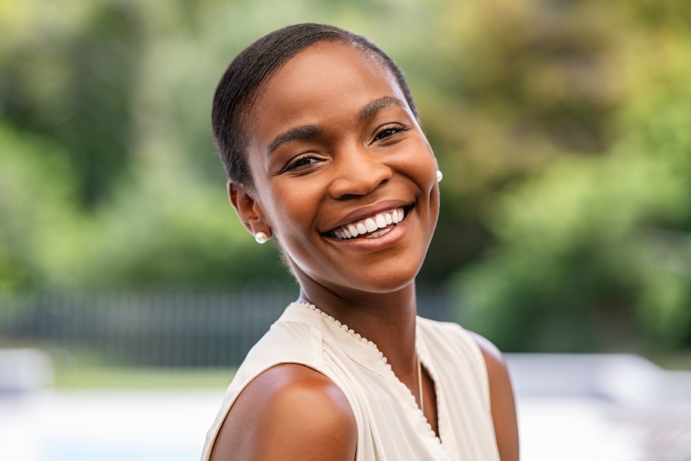 A smiling patient outdoors.